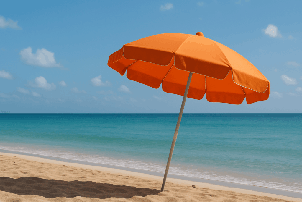 Orange umbrella on a sandy beach by the sea