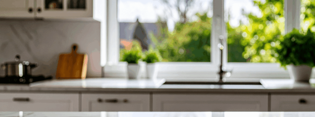 "A bright modern kitchen with a window overlooking a sunny garden"